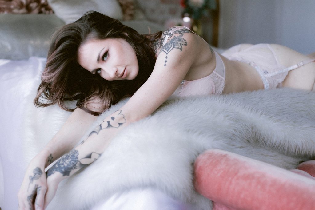 Soft sweet and romantic boudoir image in pink Victoria's secret by East Bay Area body positive boudoir photographer Heather Elizabeth